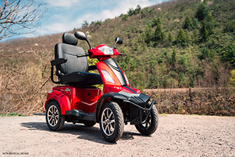 Red Baja Raptor 2 4-Wheel outdoors with hills in the background.