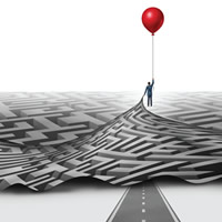 figure floating with a baloon pulling up maze